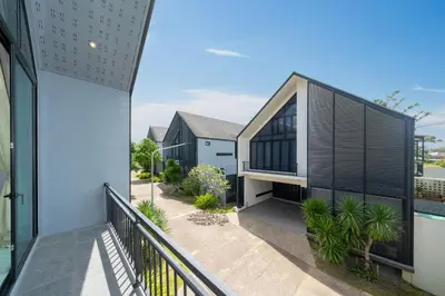 an external view of a house with a balcony at Designer Loft Villa Retreat in Pasak, Laguna Area in Ban Pak Lak