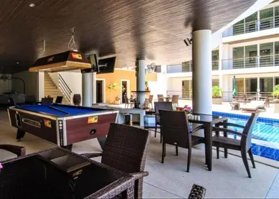 a pool room with a ping pong table and chairs at Bayshore 2 Bedroom Spacious Seaview Apartment in Patong Beach