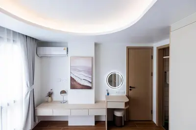 a white room with a table and a mirror at FantaSea condo Kamala 205 in Kamala Beach