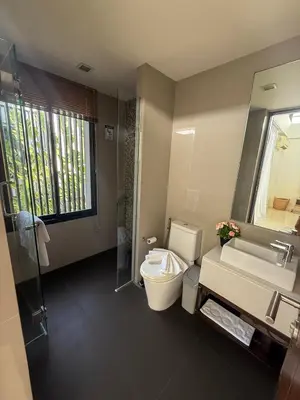 a bathroom with a toilet and a sink and a mirror at Laguna Park Phuket 5BR Villa with Rooftop Pool #84194 in Laguna Phuket