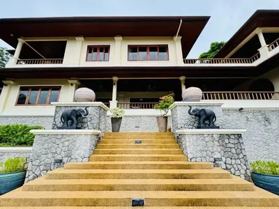 a house with stairs leading up to it at \u6574\u680b\u9ad8\u5962\u5eb7\u517b\u6cf3\u6c60\u522b\u5885 - \u5e26\u53a8\u5e08\u5973\u4f63 in Layan Beach