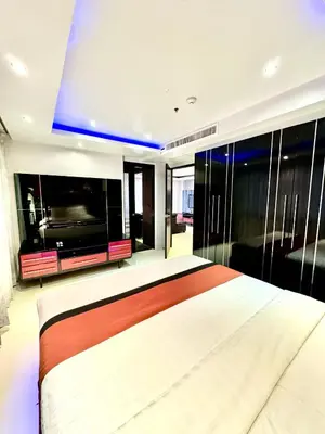 a bedroom with a large bed and a large television at L08 Penthouse Suite Modern Condo On Bangla Road in Patong Beach
