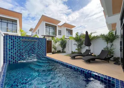 a swimming pool in front of a house at Goldena Residence Private Pool Villas in Kamala Beach