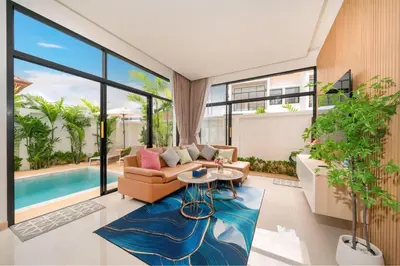 a living room with a couch and a table at Goldena Residence Private Pool Villas in Kamala Beach