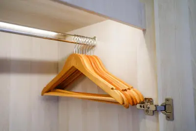 a wooden towel rack on the wall of a bathroom at Ozone Sky View Residence in Laguna Phuket