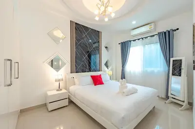 a white bedroom with a white bed and a window at Platinum Villa Rawai in Rawai Beach