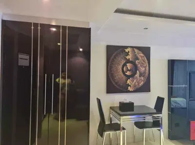 a dining room with a table and a painting on the wall at L02 Bangla Suites Modern Studio On Bangla Road in Patong Beach