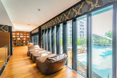 a living room with leather chairs and a large window at CityGate Condo in Magnificent Kamala Beach in Kamala Beach