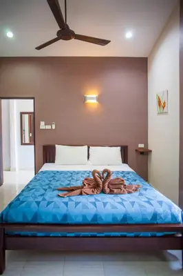 a person laying on a bed in a room at House 4 people sea view 100 m from the beach in Klong Muang Beach