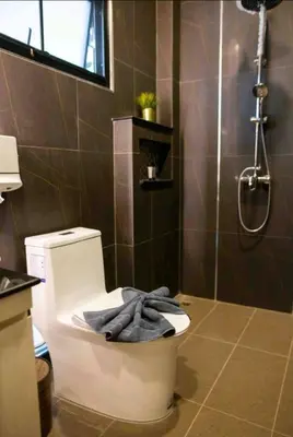 a bathroom with a toilet with a towel on it at Pool Villa Suchada 2 bedrooms in Ban Khlong Haeng