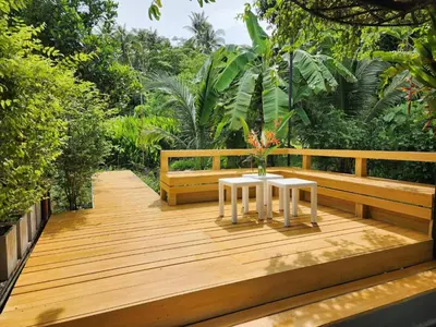 a wooden deck with a table and a bench at Pool Villa Suchada 2 bedrooms in Ban Khlong Haeng