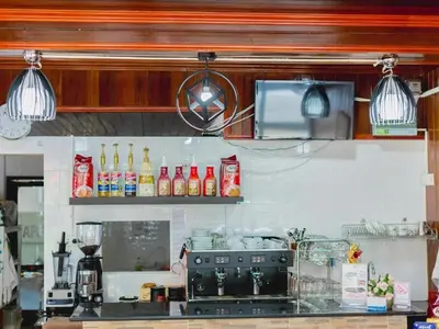 a kitchen with a counter with drinks on it at Rabbit Mansion Patong Hotel in Patong Beach