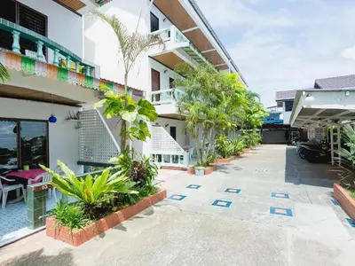 a courtyard of a building with plants at Rabbit Mansion Patong Hotel in Patong Beach