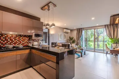 an open kitchen and living room with a large island at Majestic 2BR Residence with garden view in Regent in Bang Tao Beach