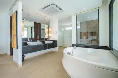 a large bathroom with two sinks and a tub at Raya Villa 2 Bed Beachfront Villa Private Pool in Rawai Beach