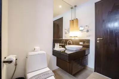 a bathroom with a white toilet and a sink at Raya Villa 2 Bed Beachfront Villa Private Pool in Rawai Beach