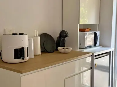 a kitchen counter with a coffee maker and a microwave at Jungle House Phuket - Seaview Retreat in Patong Beach