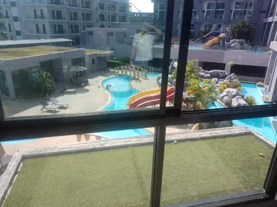 a view of a swimming pool from a window at Utopia Naiharn Loft Condo in Rawai Beach