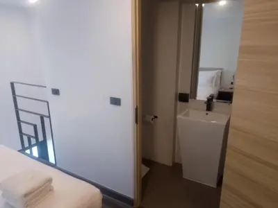 a small bathroom with a sink and a mirror at Utopia Naiharn Loft Condo in Rawai Beach