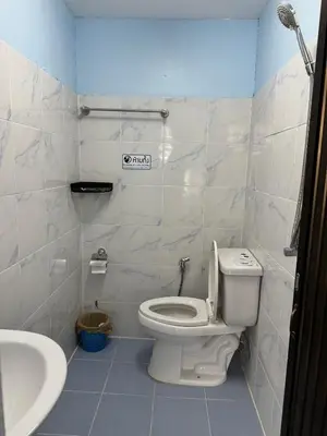 a bathroom with a toilet and a sink at Riverside Hostel Phuket in Phuket Town