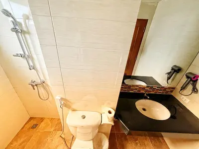 a bathroom with a shower and a toilet and a sink at Patong Leisure Hotel in Patong Beach