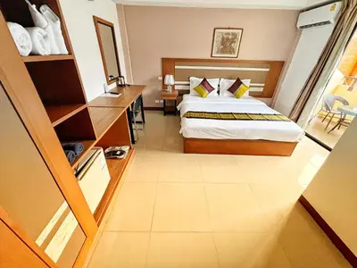 a hotel room with a bed and a mirror at Patong Leisure Hotel in Patong Beach
