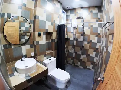 a bathroom with a toilet and a sink and a mirror at Krabi Top Sea Hill Villa in Klong Muang Beach