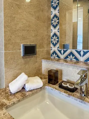 a bathroom with a white tub and a sink at Luxury Ozone Bang Tao 1 Bdr in Laguna Phuket