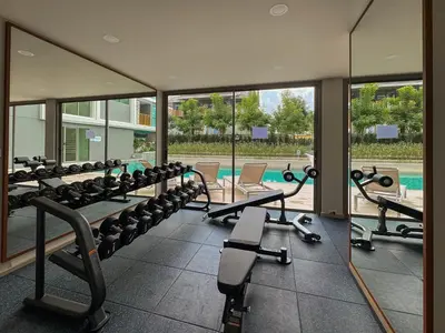 a gym with a row of treadmills and machines at Luxury Ozone Bang Tao 1 Bdr in Laguna Phuket