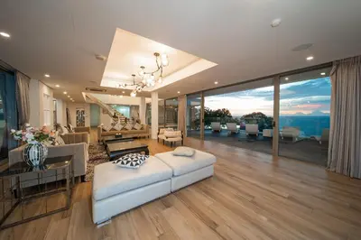a large living room with a couch and a table at Seascape 6BR Prestige Villa Skyline Pool in Kamala Beach