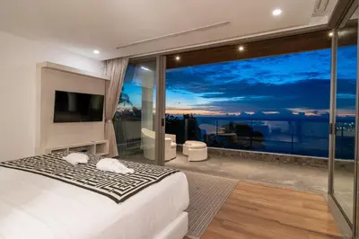 a bedroom with a large window with a view at Seascape 6BR Prestige Villa Skyline Pool in Kamala Beach