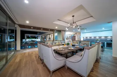 a kitchen and dining room with a table and chairs at Seascape 6BR Prestige Villa Skyline Pool in Kamala Beach