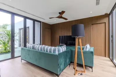 a living room with a couch and a ceiling fan at V253 Brand New 2BR with Pool and Full Kitchen in Thalang