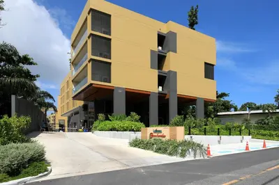 a yellow building on the side of a street at 3bdr new apartmet in Laguna 50m form beasch LBS-3504 in Bang Tao Beach