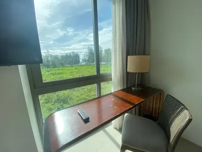 a room with a desk and a window with a remote control on it at 2bdr Apartment in Laguna Bangtao OCS-306 in Bang Tao Beach