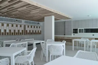 a restaurant with white tables and white chairs at 2bdr Apartment in Laguna Bangtao OCS-306 in Bang Tao Beach