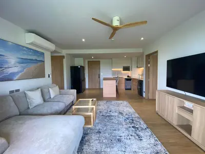 a living room with a couch and a flat screen tv at 2bdr New Apartment in Laguna near Bangtao Beach LBS-4203 in Bang Tao Beach