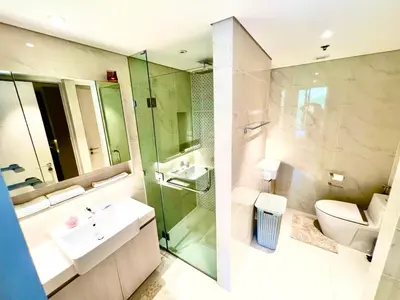 a bathroom with a toilet and a sink and a shower at 1-bedroom apartment, Cassia Phuket in Laguna Phuket