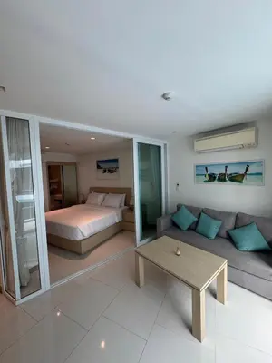a living room with a bed and a couch and a table at Beachside Bliss in Ban Saiyuan (1)