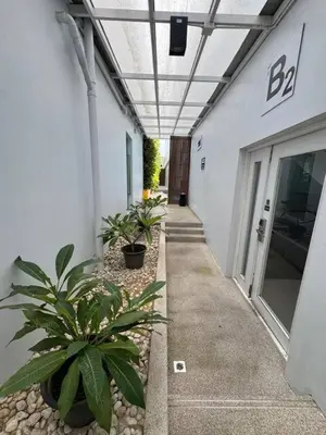 a hallway of a building with plants in front of it at Beachside Bliss in Ban Saiyuan (1)