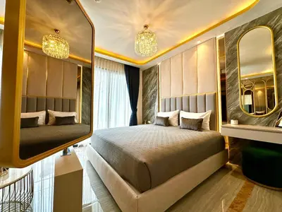 a bedroom with a large bed and two mirrors at New studio of Bangtao Bellevue Lagoon 213 in Laguna Phuket