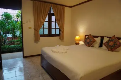 a bedroom with a large white bed with a window at Residy Downtown Hotel in Patong Beach