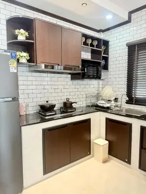 a large kitchen with brown and white appliances at PS House Bangtao in Bang Tao Beach