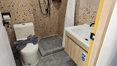 a bathroom with a toilet and a sink at CK House in Patong Beach