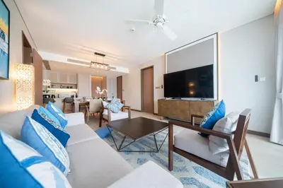 a living room with a couch and a table at Luxury 2BR Suite Lakeside Angsana Laguna in Phuket Town