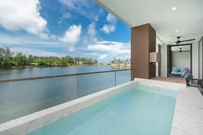 a swimming pool with a view of a river at Luxury 2BR Suite Lakeside Angsana Laguna in Phuket Town