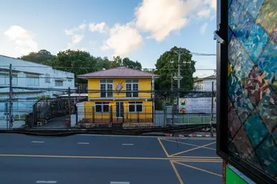a yellow building on the side of a street at Nyonya Maison Boutique Hotel Phuket Old Town in Phuket Town