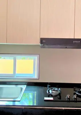 a kitchen with a stove and a sink and a window at Chalong pool villa in Ban Na Bon