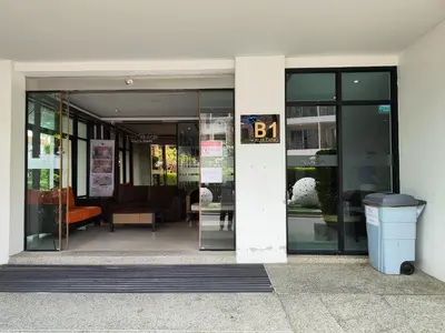 an entrance to a building with a trash can outside at 4 Floor - Pool view Studio room at TBHR near Kata beach in Kata Beach