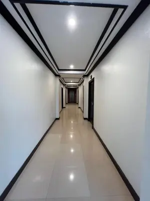 a long corridor with white walls and a ceiling at SVAH Boutique Patong in Patong Beach
